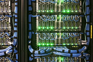 Servers with CAT 5 cables on racks  in a large computere server farm.